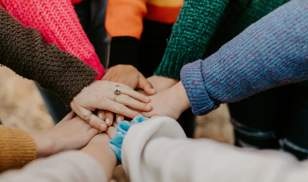 people putting hands together